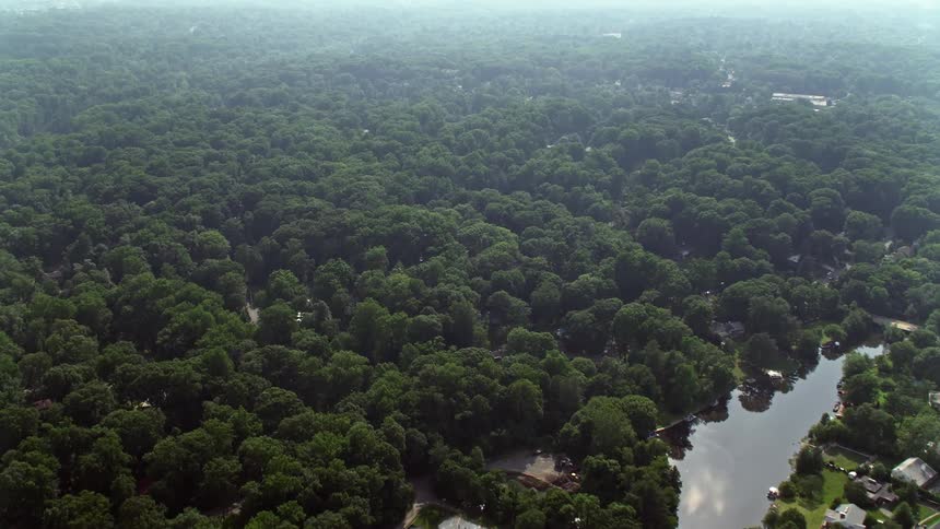 An aerial view of Stuart High School beside Lake Barcroft in Falls Church Virginia on a hazy day