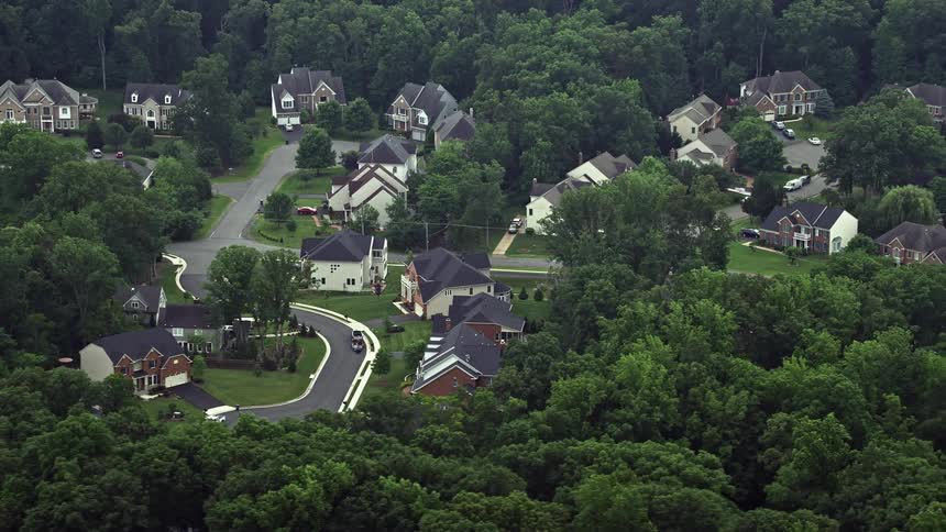 A stunning aerial view of luxurious upscale homes lining quiet streets in the bedroom community of Springfield Virginia during the summertime