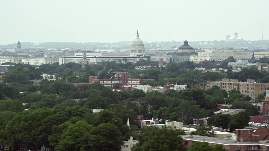 Aerial footage of the United States Capitol and Thomas Jefferson Building in Washington DC on a hazy day