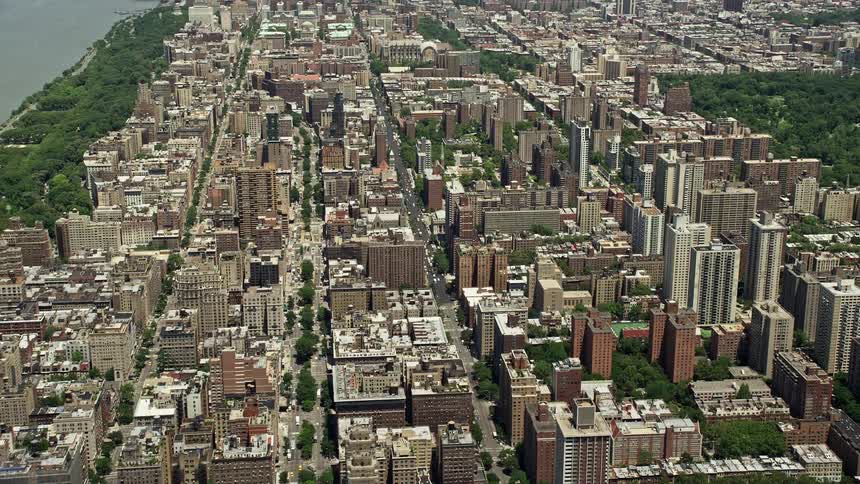 A sunny aerial view of the Upper West Side high-rises and wide avenues in New York City during summertime
