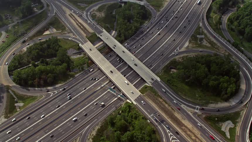 Aerial footage of Interstate 495 overpass in Annandale VA during a partly cloudy day with light traffic