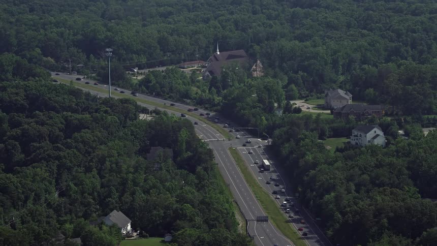 Aerial view of small rural churches and homes along Ox Road in Fairfax Station Virginia during summer