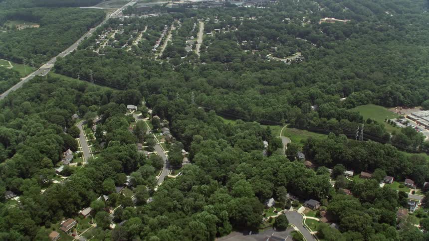 Aerial footage of residential suburbs in Springfield Virginia with large green trees visible