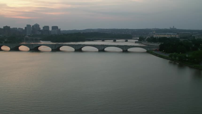 Approaching Arlington Memorial Bridge over the hazy Potomac River during twilight in Washington DC