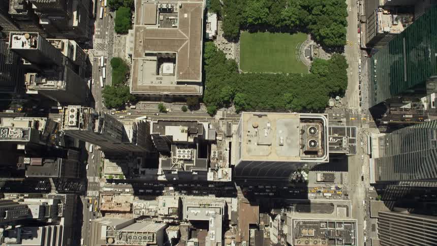 A breathtaking birds eye view of Midtown skyscrapers Bryant Park and the New York Public Library during a sunny summer day