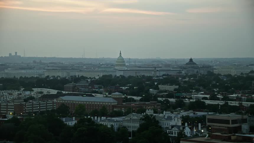 Aerial footage of Washington DC at twilight featuring the Capitol dome Library of Congress and House office buildings