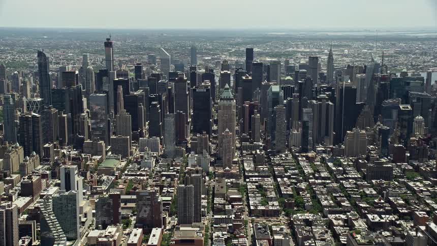 A stunning aerial view of Midtown Manhattan skyscrapers in New York City during a sunny day