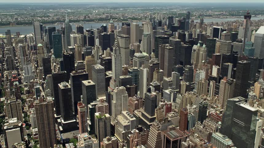 Discover the breathtaking beauty of New York Citys skyline - watch as the Chrysler Building and towering skyscrapers reveal the impressive Citigroup Center in stunning aerial footage