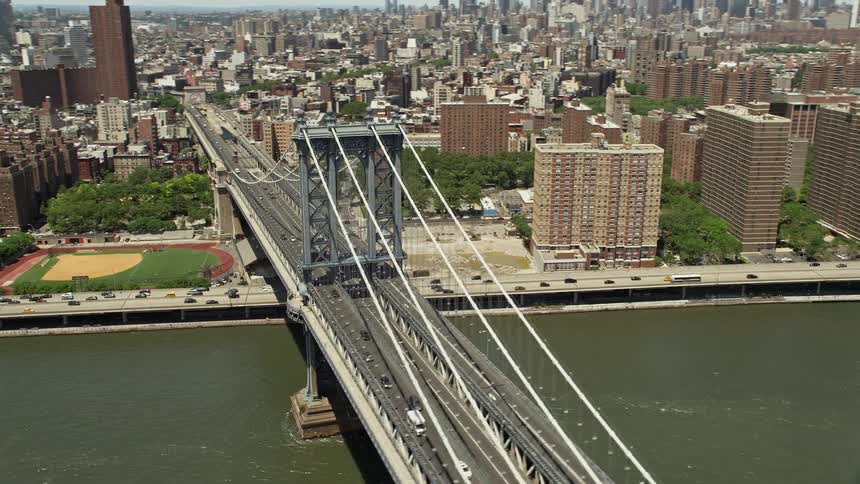 Aerial view of Manhattan Bridge in Lower Manhattan New York City with light traffic passing over it during the daytime in summer