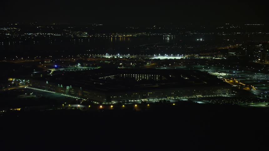 A stunning aerial footage of the iconic Pentagon government building in Virginia as it shines brightly under a clear summer sky at night