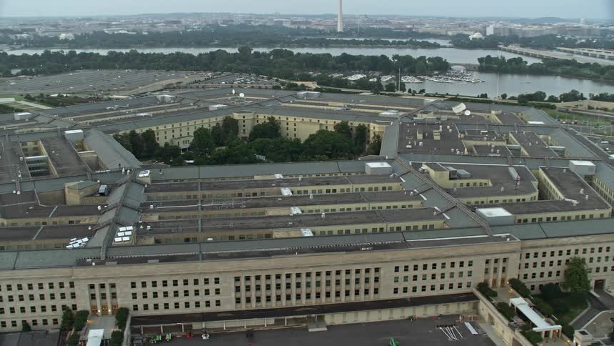 A twilight aerial clip of The Pentagon in Washington DC over the bustling government landmark and armed forces center courtyard as seen during summers haze
