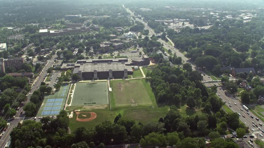 Aerial footage flying over suburban homes and government office buildings to approach an elementary school in Arlington Virginia
