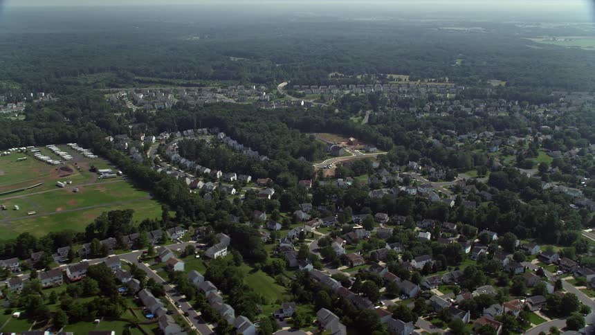 Aerial view of suburban neighborhoods and fairground in Manassas Virginia during a hazy summer day