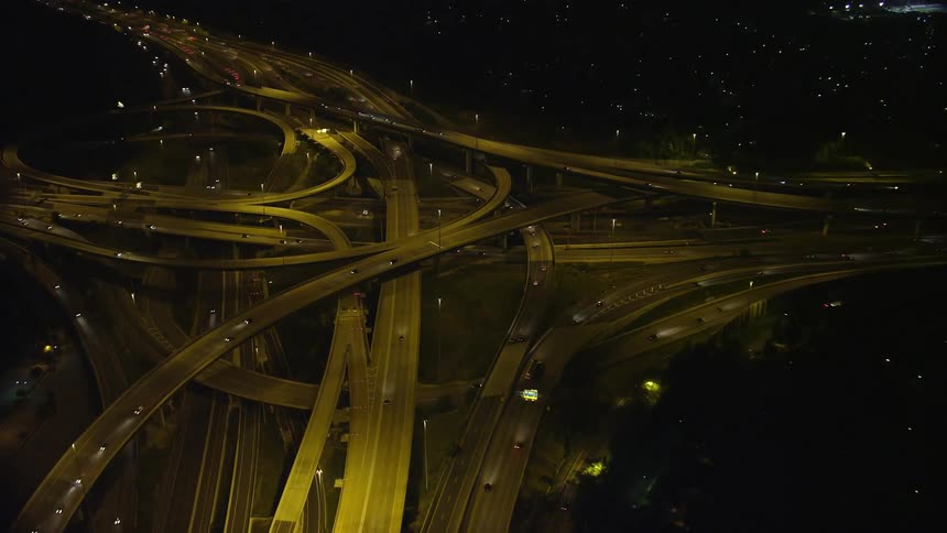 An aerial view of a highway interchange at night in Springfield Virginia showing light traffic flowing through the freeway