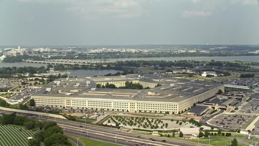 Aerial footage of The Pentagon in Arlington Virginia orbiting over the George Mason Memorial and Rochambeau Memorial bridges and showing the traffic below during the daytime