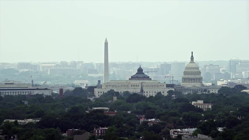 Aerial footage of the United States Capitol Thomas Jefferson and John Adams Buildings and the Washington Monument in hazy weather in Washington DC
