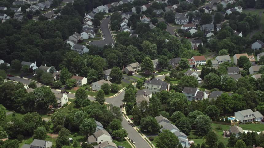 A beautiful aerial view of a dense suburban neighborhood in Manassas Virginia during a partly cloudy day