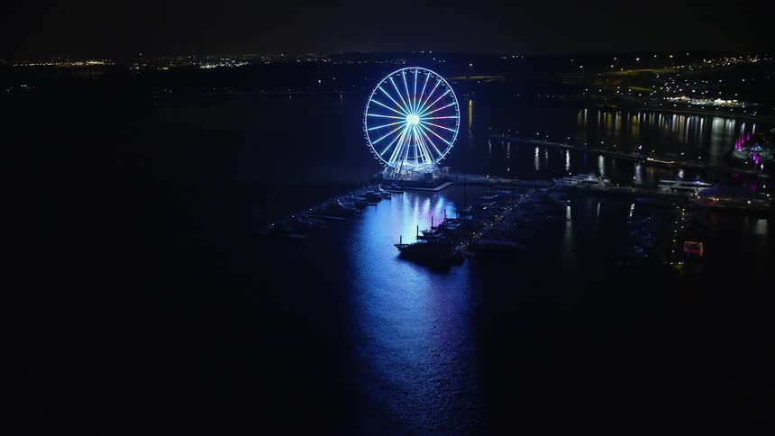 Enjoy an incredible view of the Capitol Wheel and the National Harbor Marina at night in Maryland