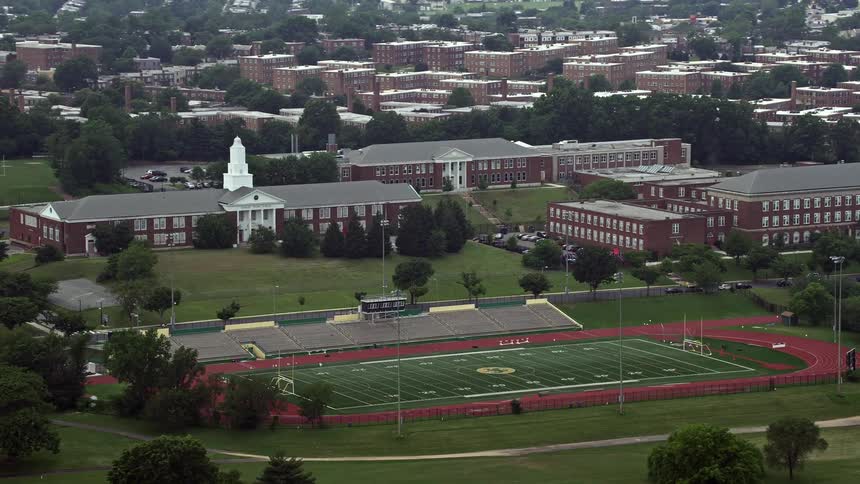Aerial footage of Charles Young Elementary School beside a high school football field in Washington DC