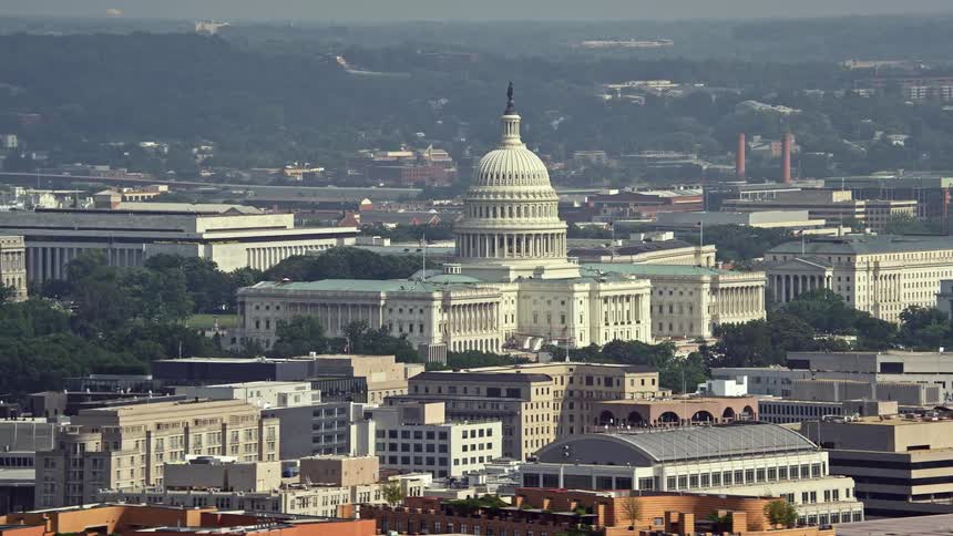 A hazy aerial view of the United States Capitol building in Washington DC during daytime