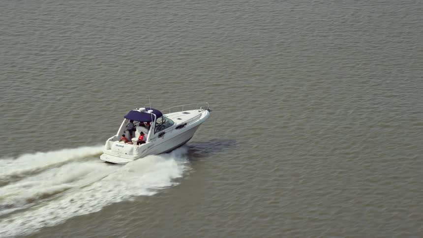 Aerial footage of a speedboat cruising on the Potomac River in Washington DC on a sunny day