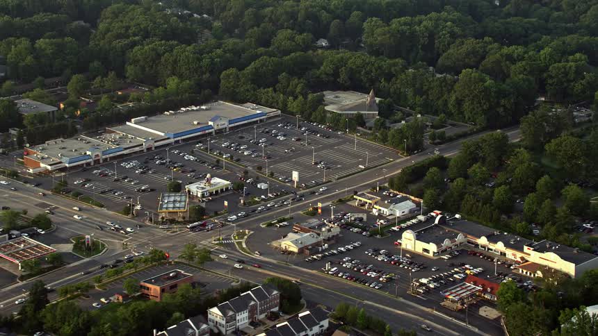 An aerial view of cozy townhouses located near a strip mall in Springfield Virginia during sunset