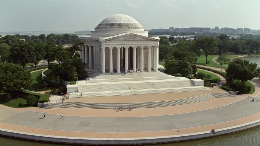Aerial footage showcases the iconic Jefferson Memorial in Washington DC during a sunny day revealing the statue of Thomas Jefferson inside