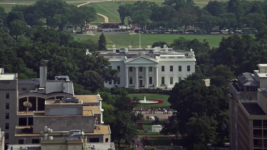 Aerial footage of the North Side of the White House with an American flag flying on top