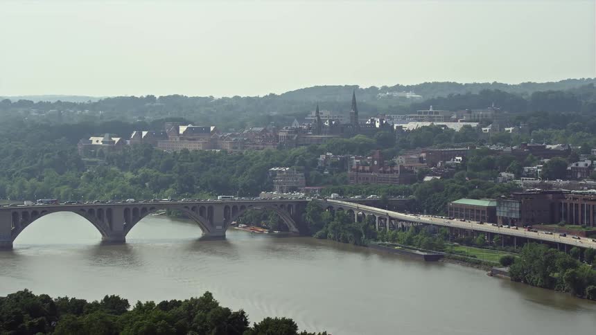 A stunning aerial view of Georgetown University and Francis Scott Key Bridge over the Potomac River in Washington DC during summer