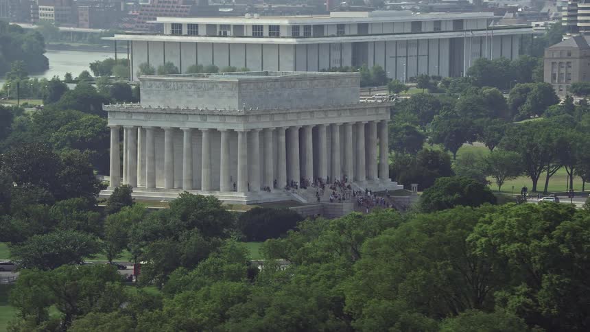A stunning aerial view of the Lincoln Memorial landmark at the National Mall in Washington DC surrounded by tourists on a beautiful summer day