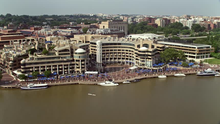 A sunny daytime aerial view of Washington Harbour residential and condo complex by the Potomac River in Georgetown Washington DC
