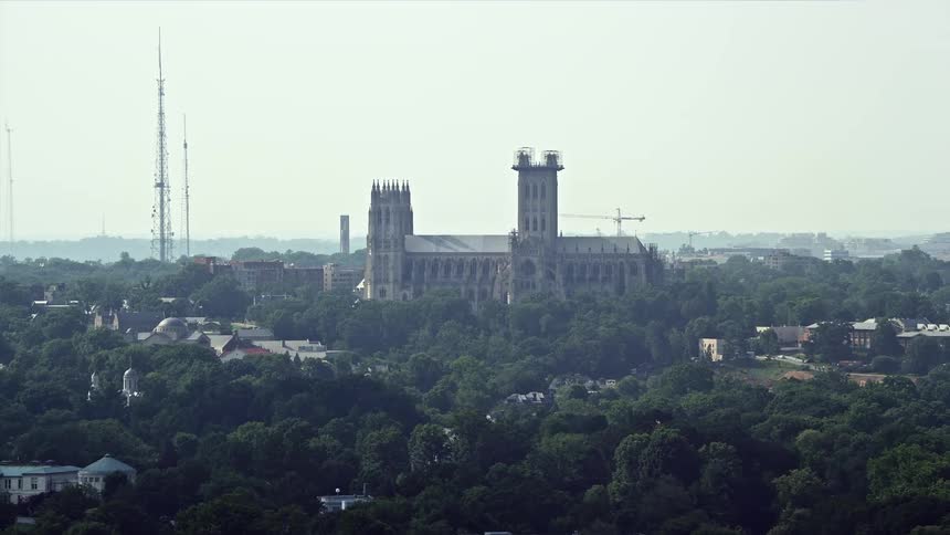 Aerial footage of the Washington National Cathedral a historic landmark and holy site captured during a hazy summer day in Washington DC