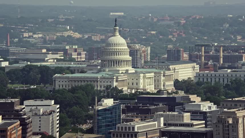 A stunning daytime aerial view of the United States Capitol building in Washington DC during summer haze