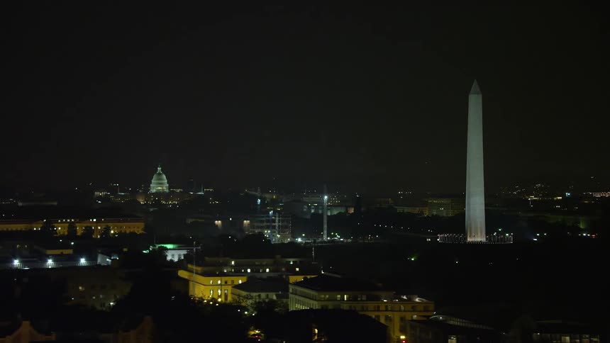 A nighttime aerial view of the United States Capitol and Washington Monument on the National Mall in Washington DC
