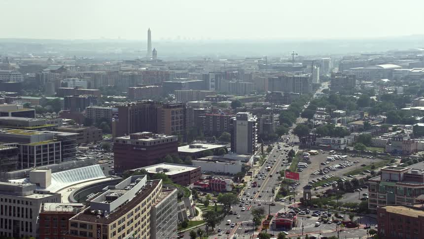Aerial view of Washington DC office buildings on New York Ave with the iconic Washington Monument in the distance