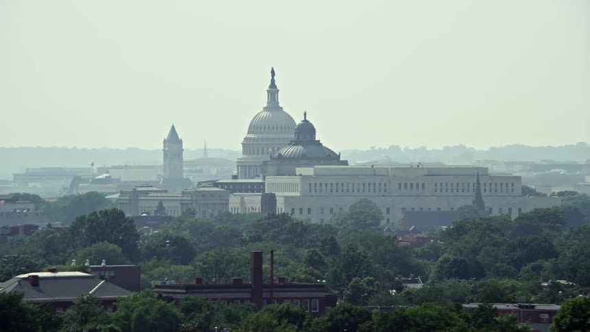 Aerial footage of the United States Capitol Dome between the James Madison and Thomas Jefferson Buildings in Washington DC on a sunny day during summer