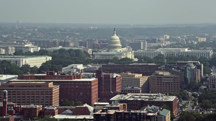 Aerial footage of office buildings the United States Capitol and the Rayburn House Office Building in Washington DC during summer