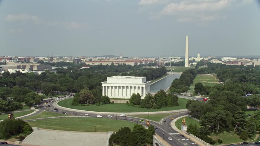 A sunny aerial footage of Lincoln Memorial orbiting over the National Mall to reveal famous landmarks in Washington DC