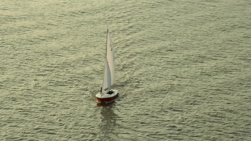 An aerial view of a sailboat on the Potomac River during sunset in Washington DC