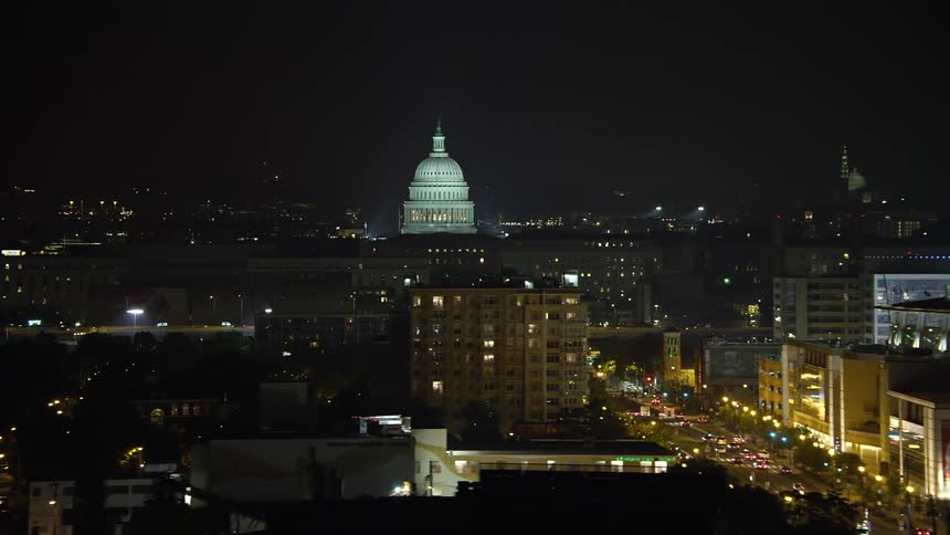 A stunning night aerial view of the United States Capitol a famous government building in Washington DC