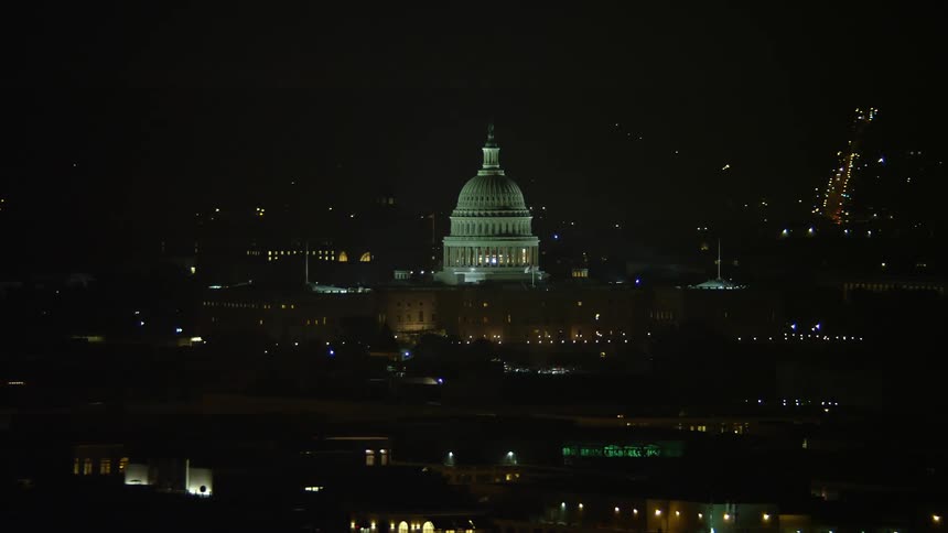 A nighttime aerial shot of the iconic United States Capitol building in Washington DC