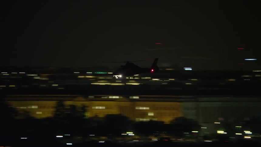 Aerial footage of a helicopter flying over the National Mall in Washington DC at night
