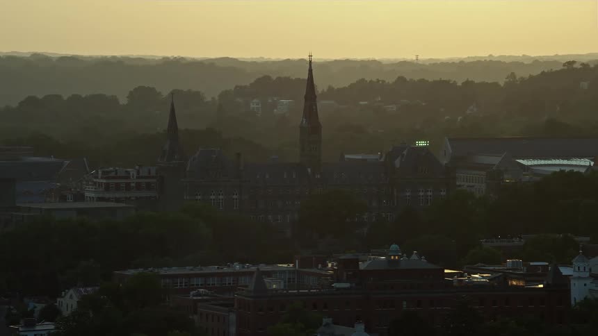 Aerial footage captures Georgetown University in Washington DC under a hazy sunset