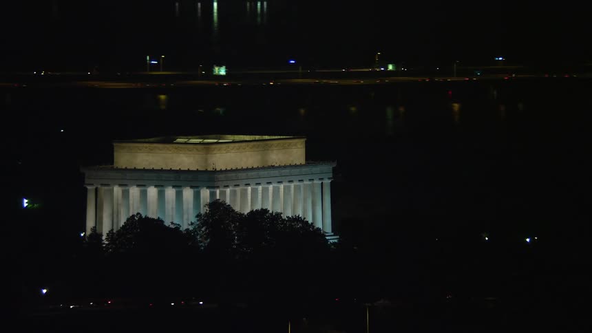 A breathtaking aerial view of the Lincoln Memorial and the Tidal Basin in Washington DC captured at night during summer showcasing the iconic landmark in its glory
