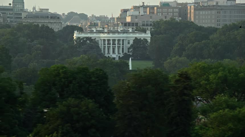 Aerial view during sunset of the iconic structure The White House and surrounding park and fountain in Washington DC