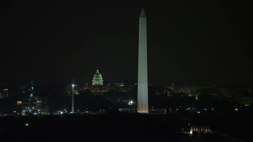 A nighttime aerial view of the United States Capitol Building and the Washington Monument in Washington DC