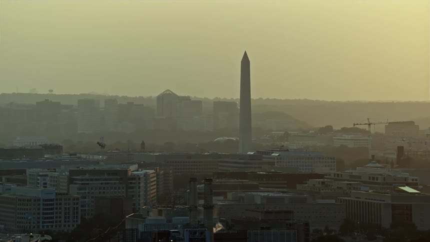 Aerial sunset footage of the Washington Monument and government office buildings in Washington DC
