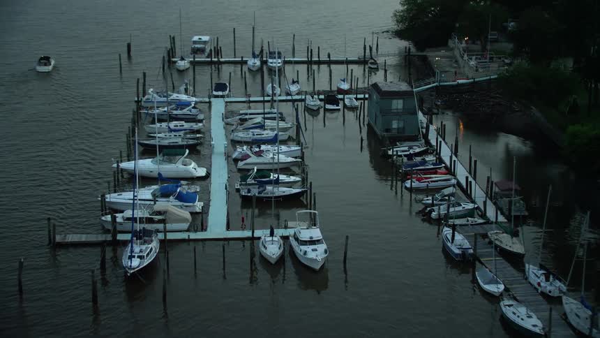 Aerial footage captures docked boats at a marina on the Potomac River in Washington DC during twilight