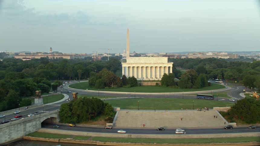 Aerial footage at sunset of Washington DC featuring the Lincoln Memorial Reflecting Pool Washington Monument and National Mall landmarks