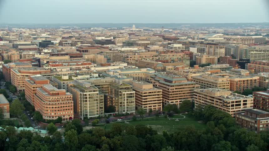 A stunning aerial view during sunset of apartment and office buildings in Washington DC along with the distant Washington Monument